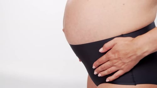 Pregnant Woman Holding Tightly onto Her Belly