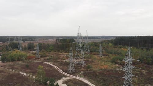 Transmission electricity steel pylon towers in forest. Electric tower lines. Environmental problem