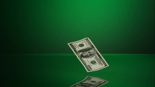 Money Falling on Green Reflective Surface
