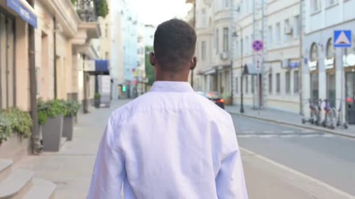 Back View of African Man Walking on the Street