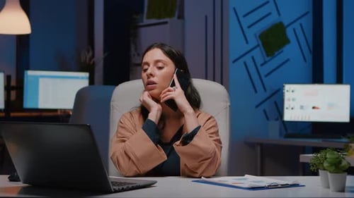 Woman Working at Night in Urban Office