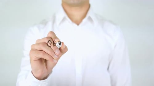 Man Writes Best Travel Offers on Clear Surface