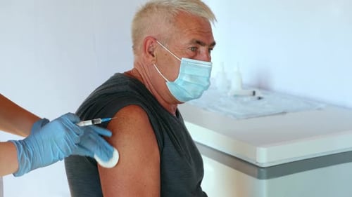 Senior Man Getting Vaccine Injection in Arm