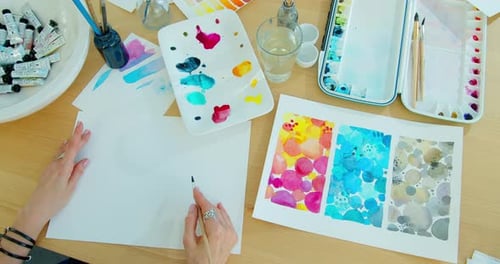 Closeup of Women's Hand with Brush Drawing on Paper. Creation Process of Watercolor Painting.