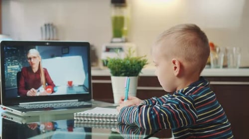 Boy Learning Online With Woman On Laptop