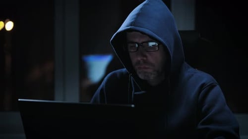 Hacker in a Dark Room Writes Malicious Code