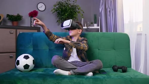 Teen Boy Using VR Headset on Sofa