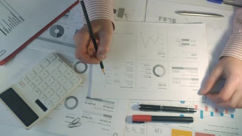 Businessmen Working at Office Desk and Checking a Financial Report