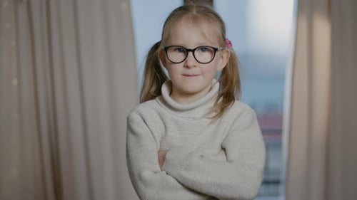 Smiling Girl Posing Indoors With Arms Crossed