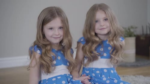 Two Cute Girls Smiling Together Indoors
