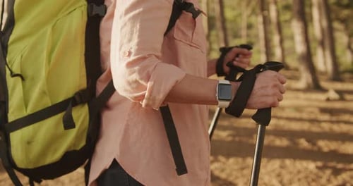 Active senior woman hiking in forest