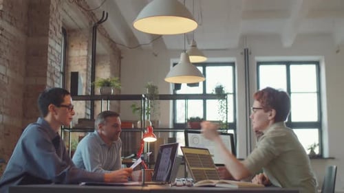 Colleagues Discussing Project at Coworking Office Table
