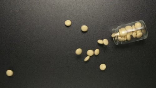 Glass jar falls and yellow pills fall out of him