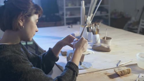Female Artist Sculpting in Her Studio