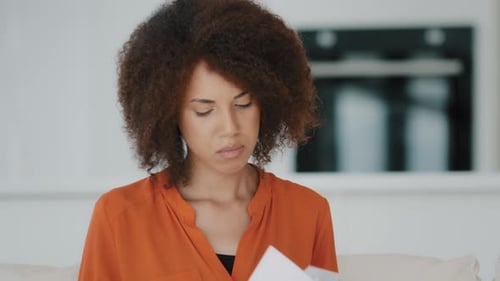 Woman Reads Letter with Excitement and Joy