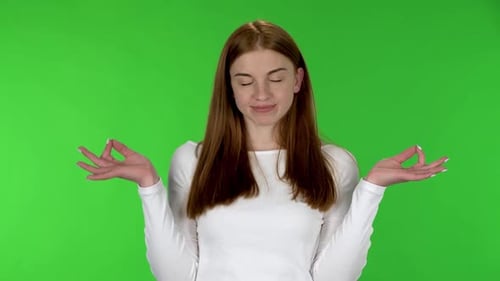 Young Woman Meditates with Hand Mudra on Green