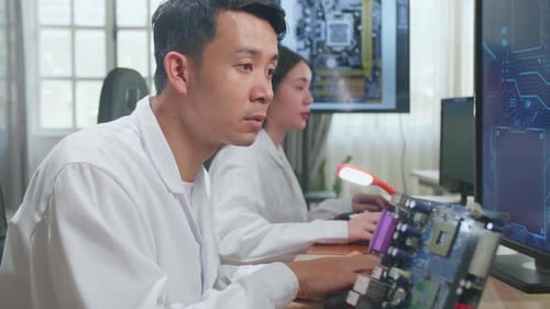 Asian Male Engineer Works On Computer With Cad Programming Software, Design Of Industrial Pcb