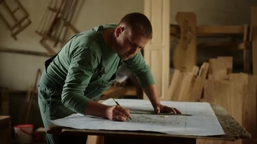 Craftsman Drawing Intricate Designs in a Woodshop