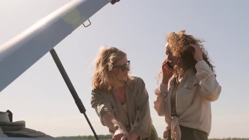 Women Travelers by Car Having Problems Calling for Help