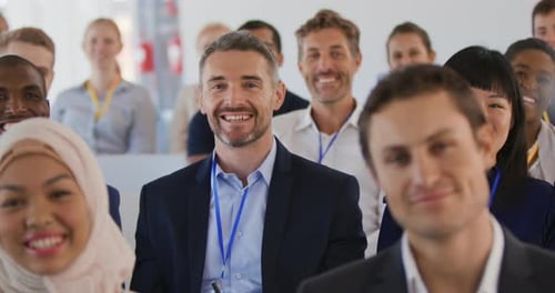 Diverse Professionals Smiling and Waving at Conference