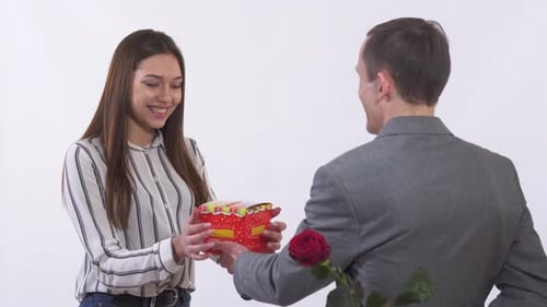 Woman Receives Gift and Rose From Man