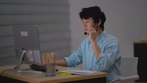 Asian business man with green shirt work as operator or call center consult the problem