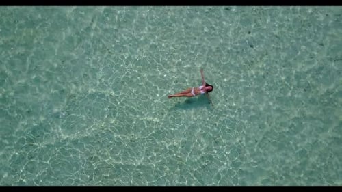 Lady sunbathes on exotic island beach vacation by blue ocean with white sand background of the Maldi