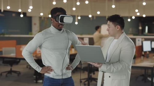 Men Collaborating with VR Headset in Modern Office
