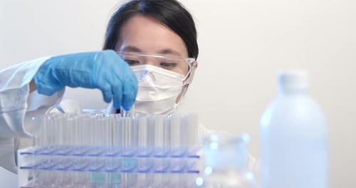 Woman Scientist Holding a Test Tube in Lab
