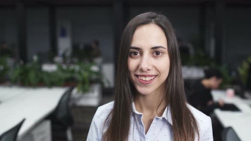 Smiling Woman in Modern Open Plan Office