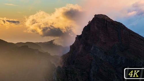 Golden Clouds Flow Through the Mountain Peaks