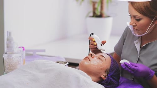 Woman Receives Facial Treatment in Beauty Clinic