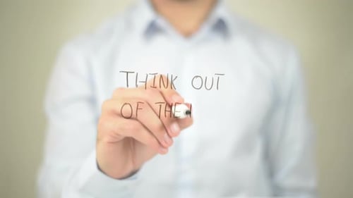 Writing Think Out of the Box on Glass Surface