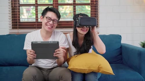 Couple Enjoying VR Together at Home on Couch