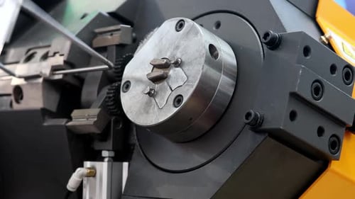 Machine Bending Silver Wire in a Factory