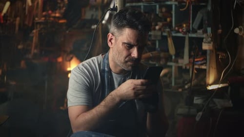 Man with Smartphone Resting After Work
