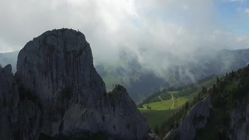 Aerial drone view of a man rock climbing up a mountain.