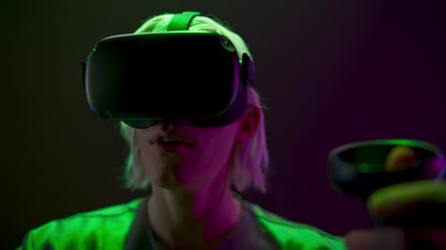 Young Adult Immersed in Virtual Reality with Headset
