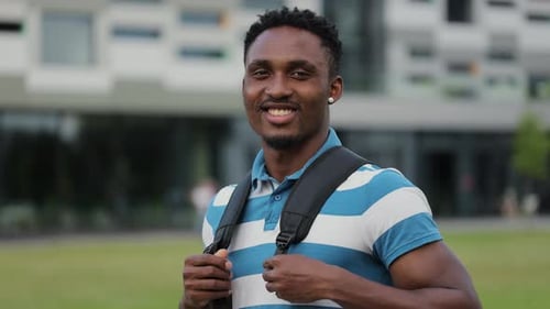 Smiling Young Adult Student with Backpack on Campus