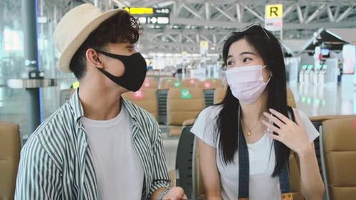 Young Couple Wearing Face Masks at Airport