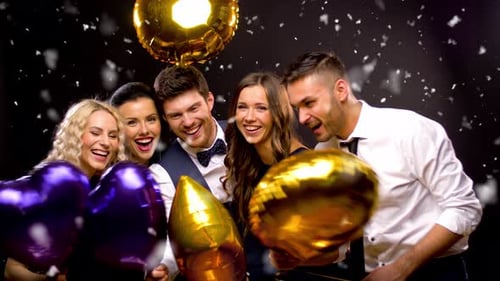 Smiling Friends Holding Balloons at Party Event