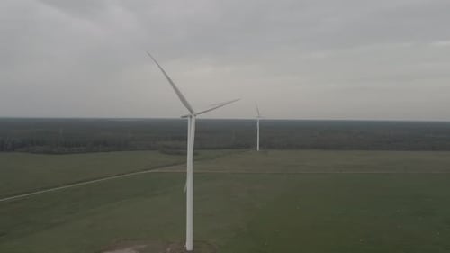 Wind Turbines Rotating in a Green Rural Landscape