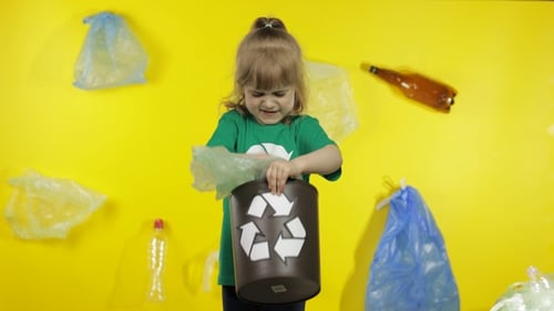 Girl Activist Collects Cellophane Packages and Put Them in Bin Dump. Trash Plastic Nature Pollution