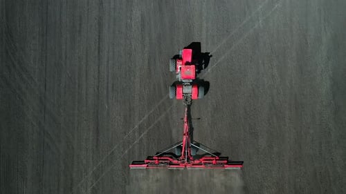 Modern Agricultural Machinery for Land Cultivation. Tractor Plows the Field for Sowing. Aerial View