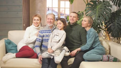 Multigenerational Family Poses on Cream Colored Couch