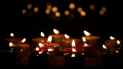 Candle Burning With Bokeh Lights
