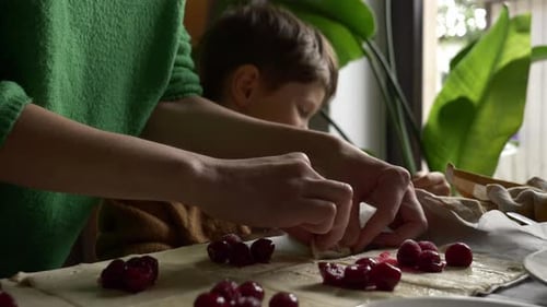 Mother and Child Baking Cherry Pastries Together