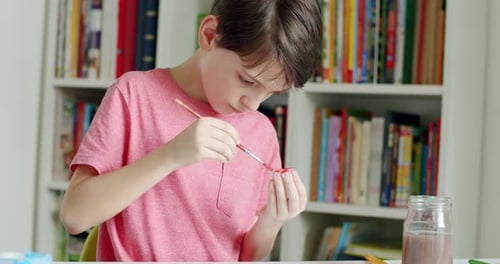 Boy Painting a Craft at Home