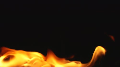 Bright Flames Flickering Against Black Background
