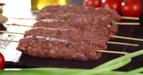 Raw Kebab Sausages on a Stick Slowly Rotate.